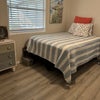 Photo 4: full size bedroom furnished with TvVand ceiling fan