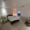 Photo 2: furnished room with double bed and large closet