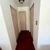 Photo 3: hallway to bathroom and double closets