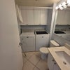 Photo 8: downstairs bathroom and laundry room