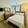 Photo 5: Queen bed, dresser, closet, TV and blackout curtains
