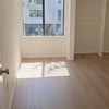 Photo 1: Partial view of bedroom; will have closet doors