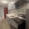 Photo 4: Newly remodeled kitchen with granite countertops and backsplash..