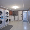Photo 9: Spacious Laundry Room | 3 Washers | 3 Dryers | All for your convinience