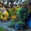 Photo 8: patio in the side yard, garage to the right for shared storage