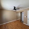 Photo 4: A clean, versatile space with natural light and room for both sleeping and workspace furniture