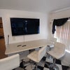 Photo 2: Smart tvs and muti function rising table for dinner or office space. 