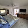Photo 2: Master Bedroom showing bed closet with mirror doors, dresser, TV and microwave