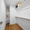 Photo 3: Spacious Walk-In Closet with Built-In Shelving