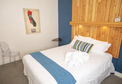 The upstairs guest room includes a comfortable que Main Photo
